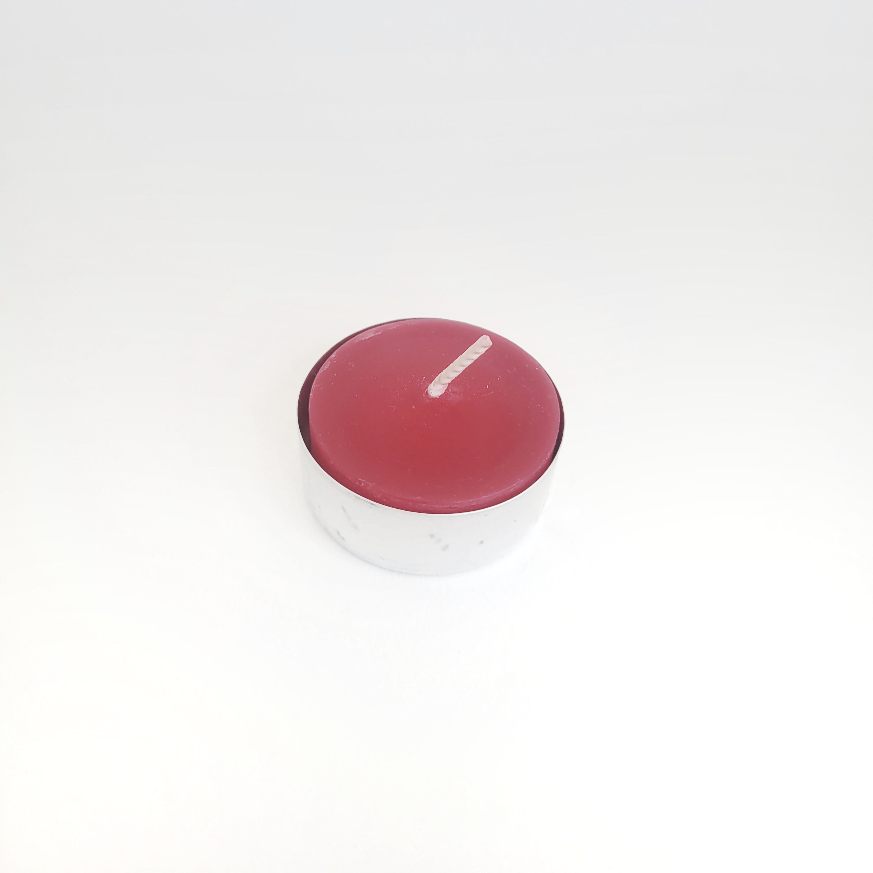 Single beeswax tealight in a tin cup, featuring a festive Christmas red color, ideal for eco-friendly holiday home decor and ambiance.
