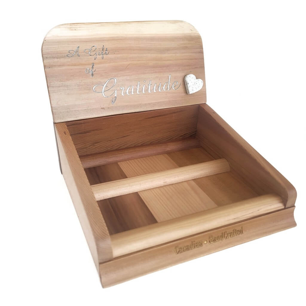 Gratitude Gift Pre-Pack Counter Display made from natural red cedar wood with silver lettering reading "a gift of gratitude" engraved in it. A white stone heart is attached to the front of the display. There is a gold engraving in the lower section of the display reading "Canadian HandCrafted"