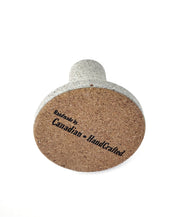 Grey Stone Taper Candle Holder on it's side with Cork bottom and 'Handmade by Canadian HandCrafted' Engraving - Detailed View on White Background