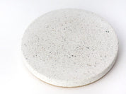 Close-up view of a sparkling white sandstone round coaster, elegant and durable design detail