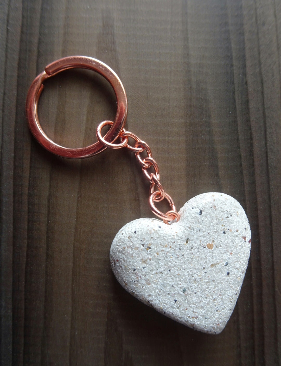 Chic Sparkling White Stone Heart Keychain with Rose Gold Hardware, Set Against a Dark Stained Wooden Background - Luxurious Accessory
