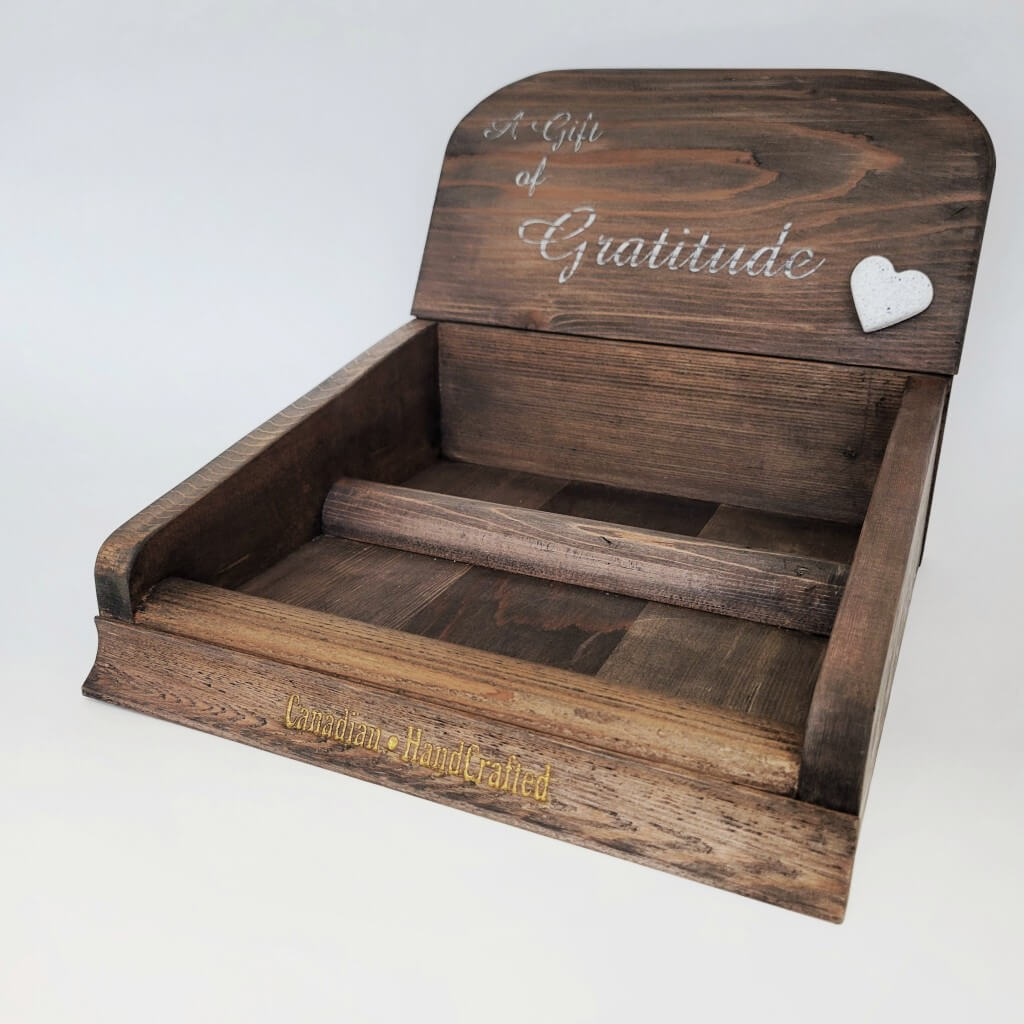 Elevate your presentation with a Gratitude Gift Pre-Pack Counter Display crafted from natural red cedar stained a rich rustic dark colour. Adorned with silver lettering engraved with 'a gift of gratitude', featuring a white stone heart affixed to the front. Spot a gold engraving at the base proclaiming 'Canadian HandCrafted'.