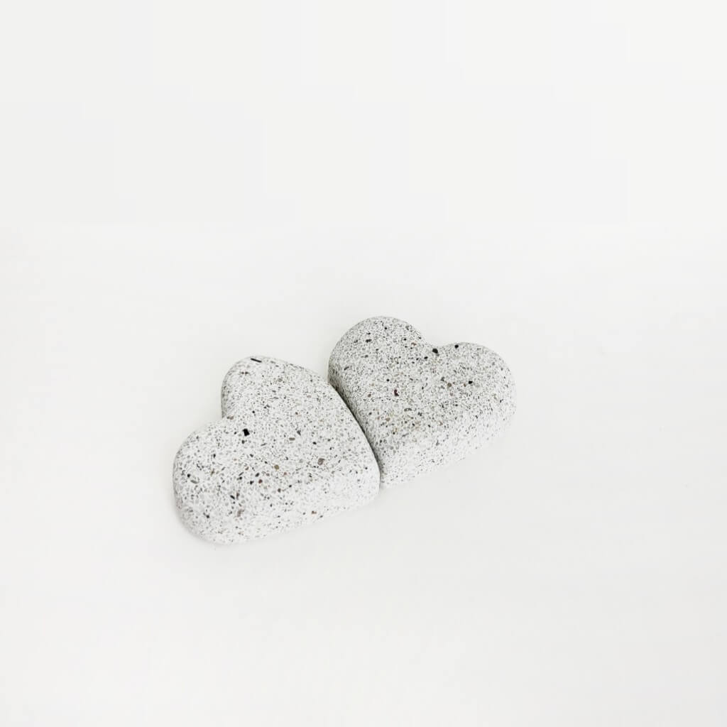 Explore two sparkling sandstone hearts shining against a pristine white background.