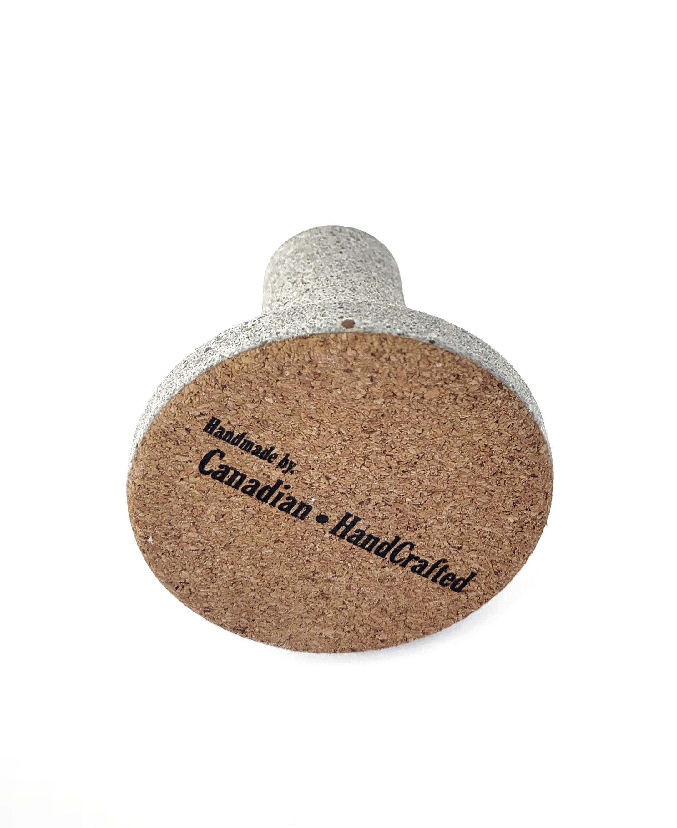 Grey Stone Taper Candle Holder on it's side with Cork bottom and 'Handmade by Canadian HandCrafted' Engraving - Detailed View on White Background