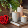 Grey Terrazzo 3-Tier tealight candle set with square stone tray next to a bright red rose.